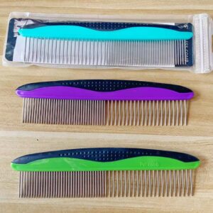 Colorful hair and pet combs arranged vertically on a wooden surface for grooming and styling.