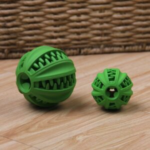 Playful green rubber balls on a wooden floor, perfect for pets or childrens activities.