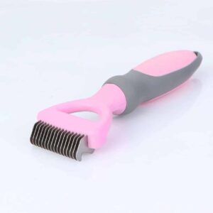 Ergonomic pink pet deshedding brush for effective grooming and reduced shedding.