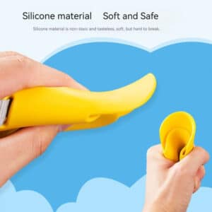 Bright yellow silicone gadget held in hand against a cheerful blue sky and clouds.